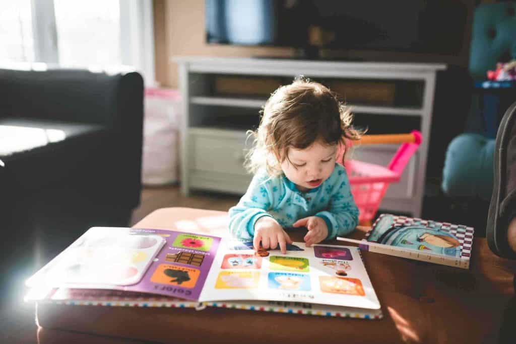 A Child Reading A Children'S Picture Books
