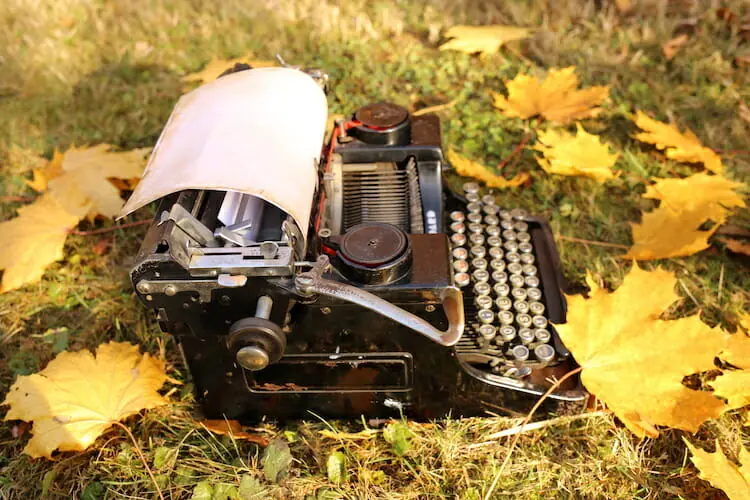 Typewriter On The Ground Surrounded By Yellow Leaves - How To Prepare For Nanowrimo
